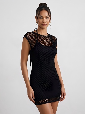 Woman wearing a black crochet mini dress beach cover-up.